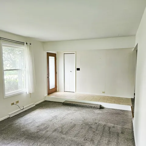 an empty room with a empty space and windows