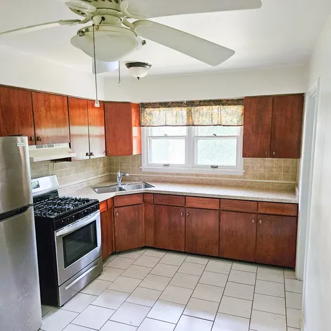 a kitchen with a stove a sink and a microwave