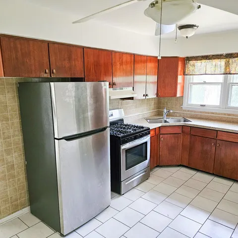 a kitchen with stainless steel appliances granite countertop a refrigerator sink and cabinets