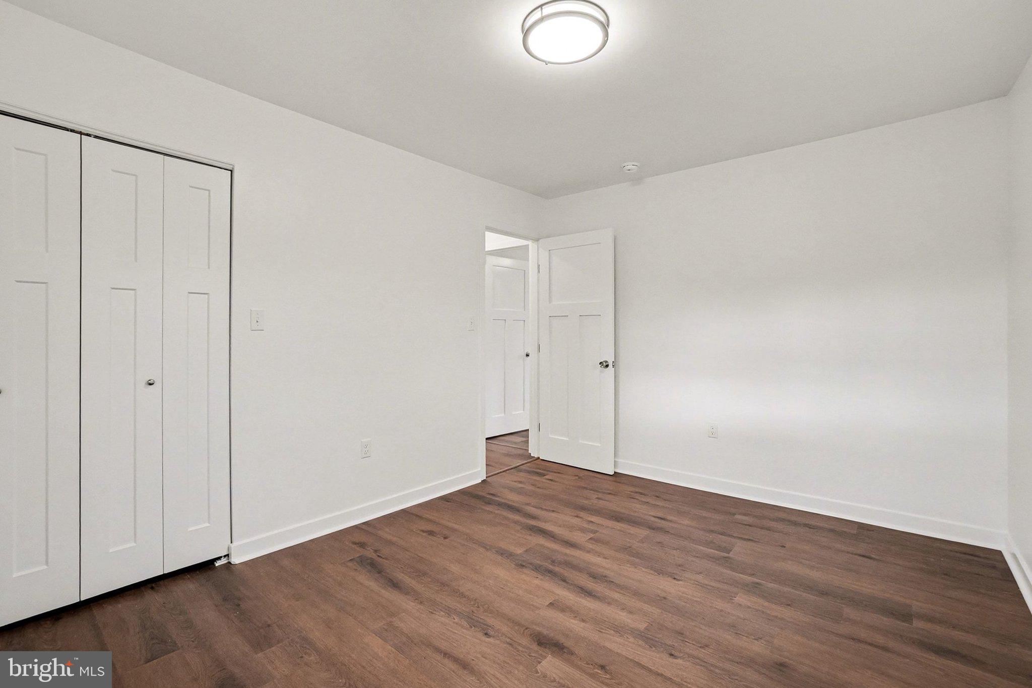6216 Locust Street Harrisburg, PA 17112 - Photo 13 of 28 a view of an empty room with wooden floor