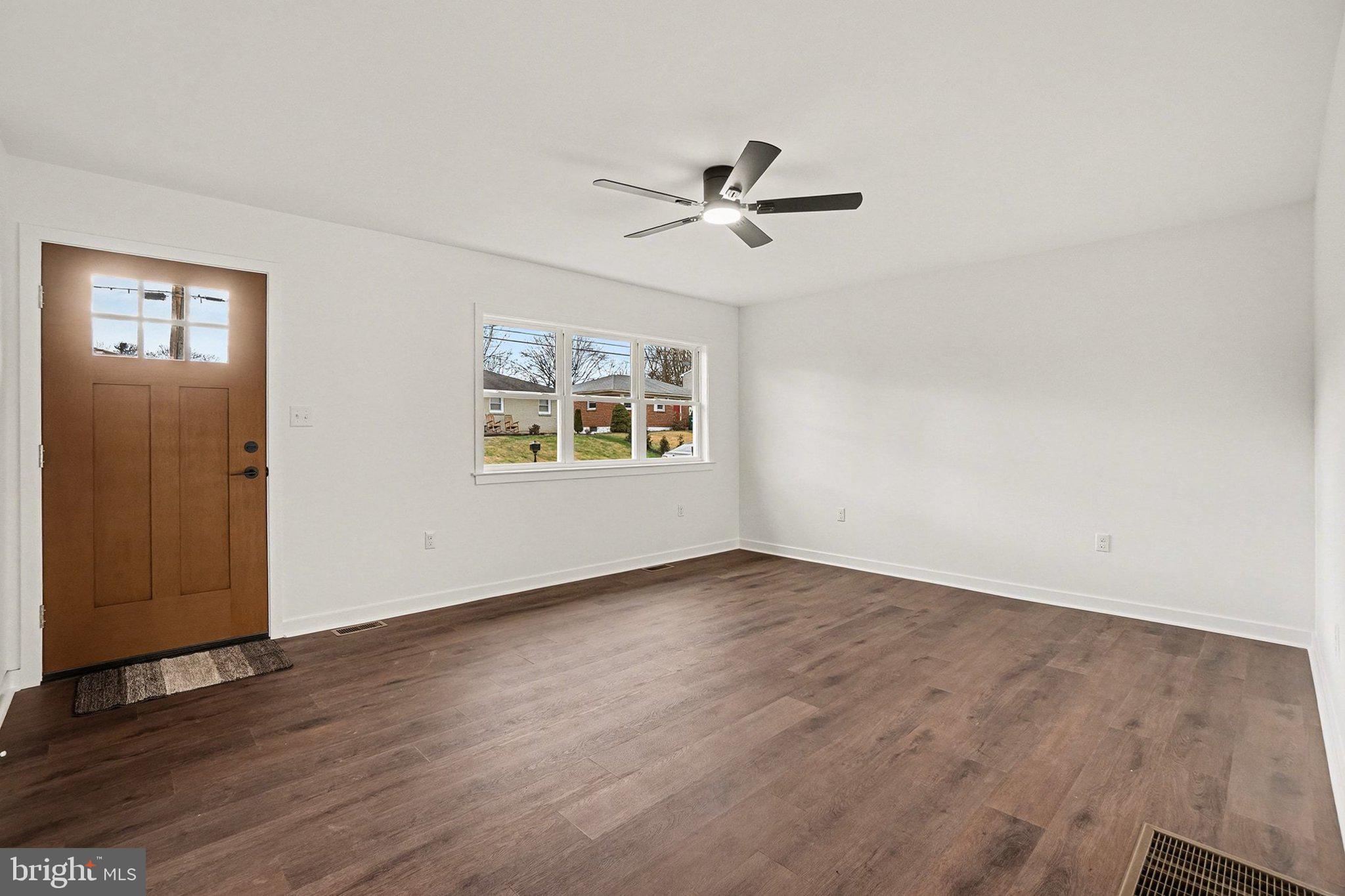 6216 Locust Street Harrisburg, PA 17112 - Photo 2 of 28 a view of an empty room with a window and wooden floor