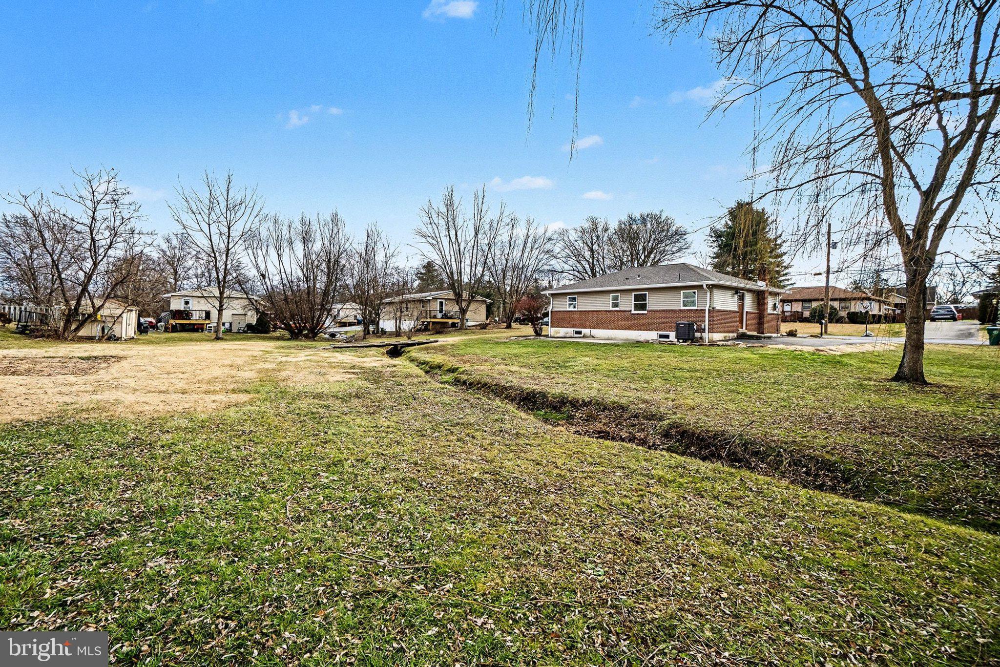6216 Locust Street Harrisburg, PA 17112 - Photo 23 of 28 a view of a house with a big yard and large trees