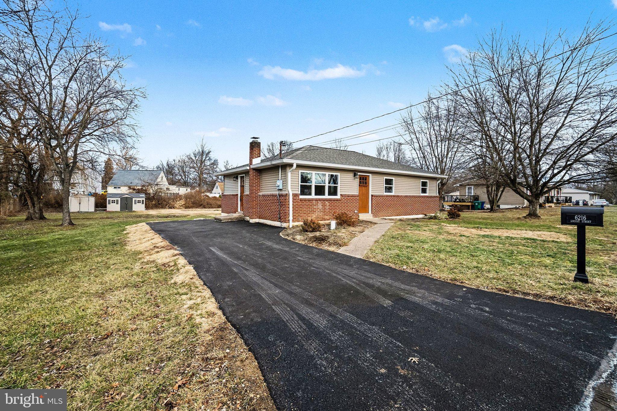 6216 Locust Street Harrisburg, PA 17112 - Photo 28 of 28 a front view of a house with garden