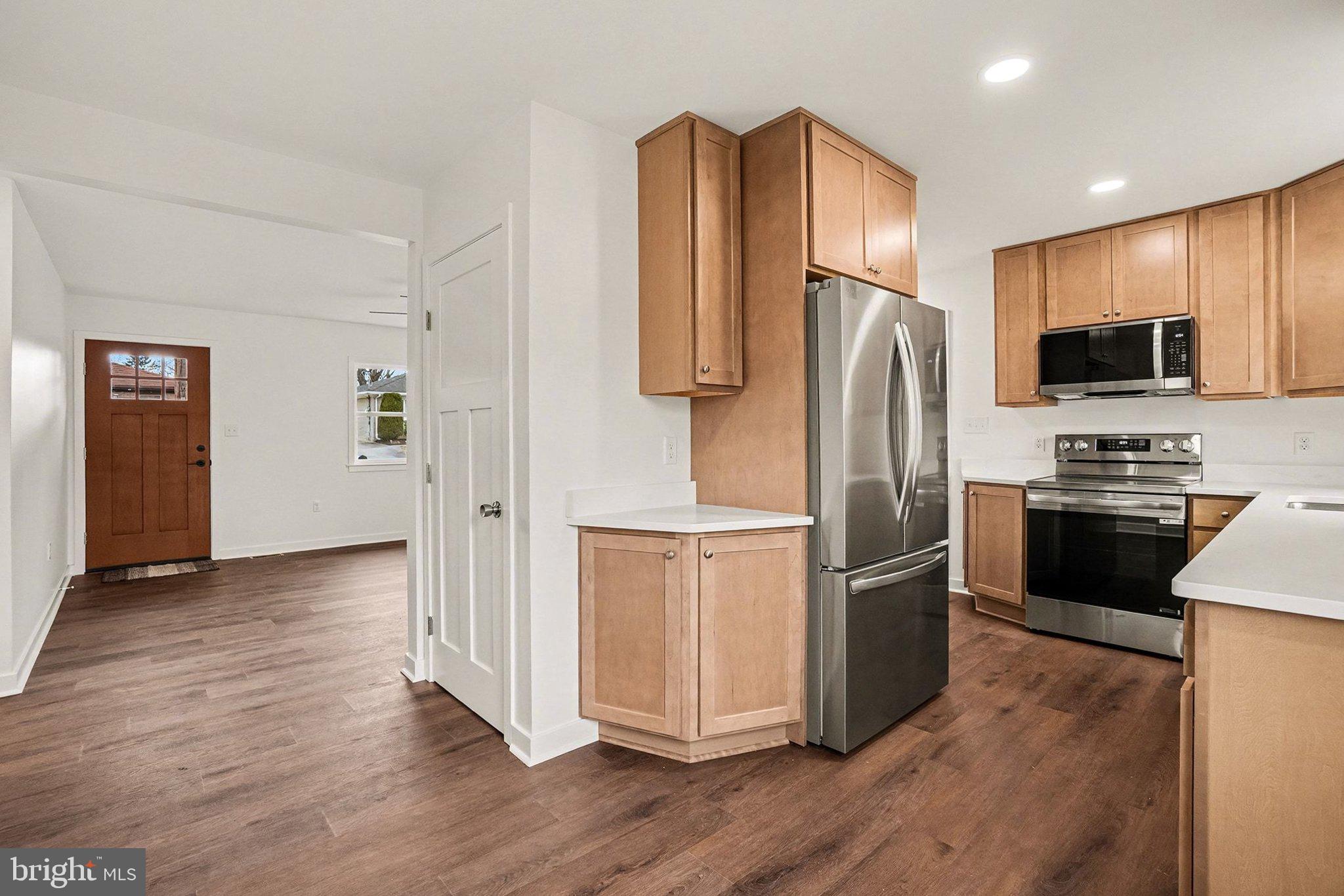 6216 Locust Street Harrisburg, PA 17112 - Photo 6 of 28 a kitchen with stainless steel appliances granite countertop a refrigerator microwave and stove