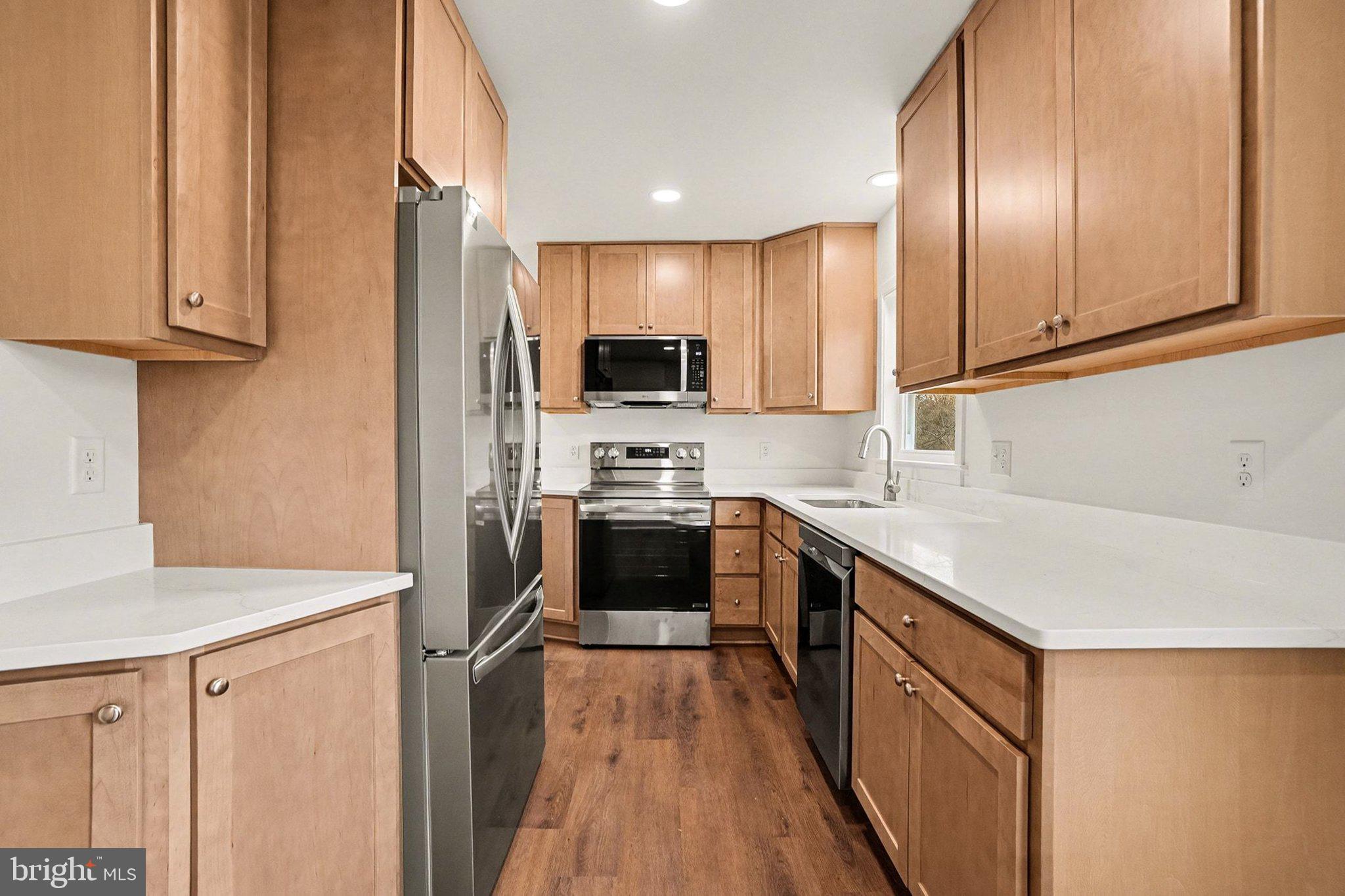 6216 Locust Street Harrisburg, PA 17112 - Photo 7 of 28 a kitchen with kitchen island granite countertop a sink appliances cabinets and counter space