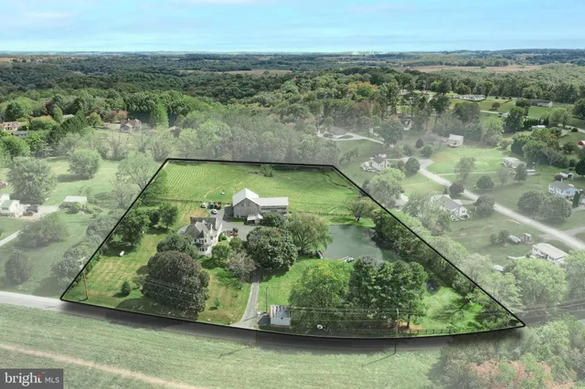 an aerial view of a houses with a yard