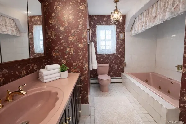 a spacious bathroom with a bathtub sink and toilet
