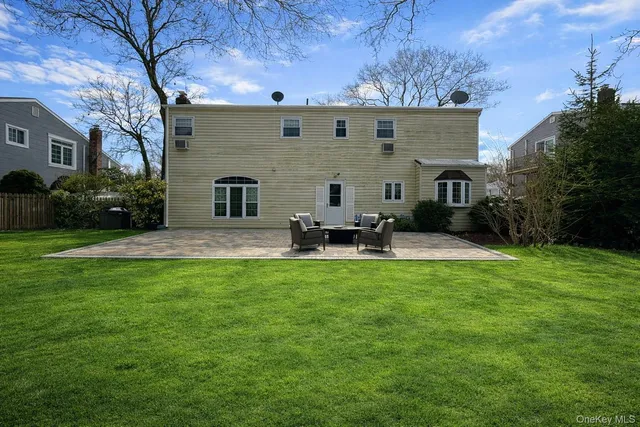 a backyard of a house with table and chairs