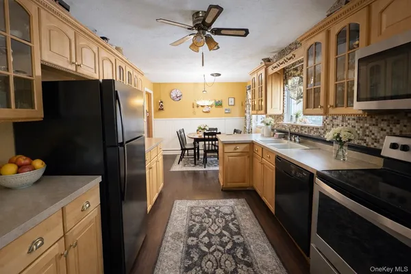 a kitchen with a sink stainless steel appliances and cabinets