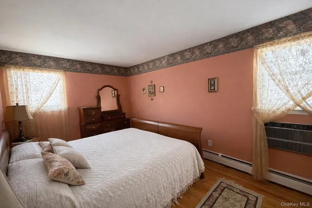a bedroom with a bed and a large window