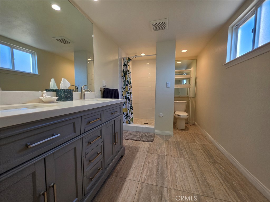 11541 Donovan Road Rossmoor, CA 90720 - Photo 51 of 113 2nd primary bathroom en-suite with dual sinks and quartz slab counters