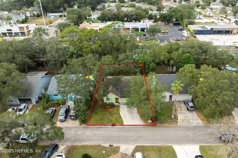 an aerial view of residential houses with outdoor space and street view