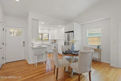 a view of a dining room with furniture and wooden floor