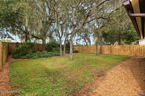 a spacious bedroom with a bed and a chandelier