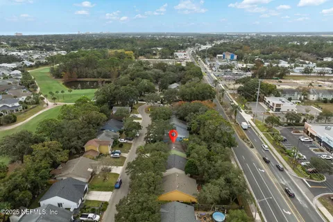 an aerial view of residential building and car parked