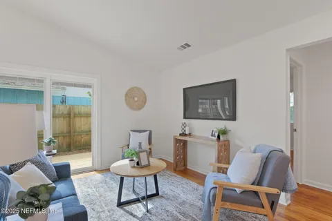 a living room with furniture and wooden floor