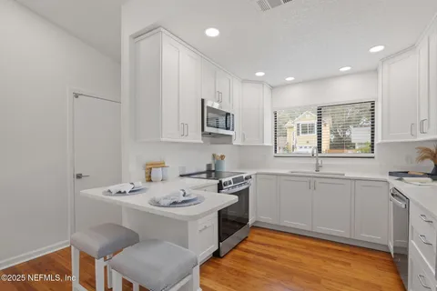 a kitchen that has a sink and a stove in it