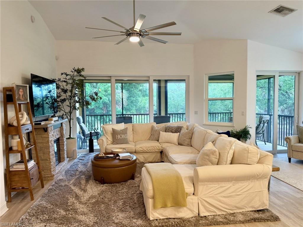 1252 Rialto Way, Unit 202 Naples, FL 34114 - Photo 11 of 26 a living room with furniture and a large window