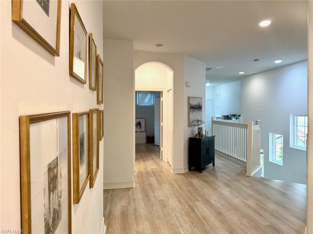 1252 Rialto Way, Unit 202 Naples, FL 34114 - Photo 13 of 26 a view of a living room with wooden floor