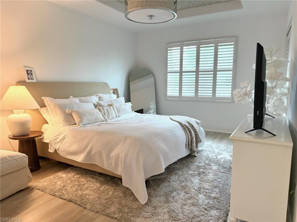 1252 Rialto Way, Unit 202 Naples, FL 34114 - Photo 16 of 26 a spacious bedroom with a bed and a window