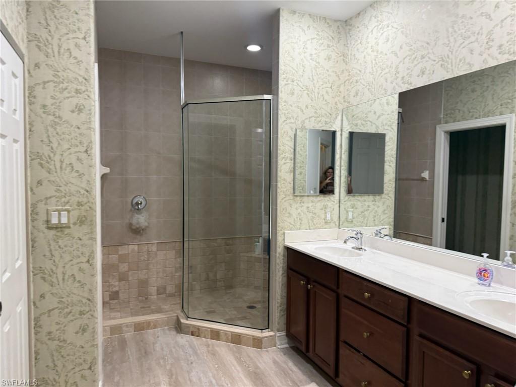1252 Rialto Way, Unit 202 Naples, FL 34114 - Photo 17 of 26 a bathroom with a double vanity sink mirror and shower