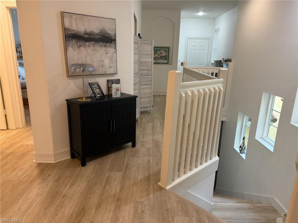 1252 Rialto Way, Unit 202 Naples, FL 34114 - Photo 19 of 26 a view of a hallway with wooden floor and windows