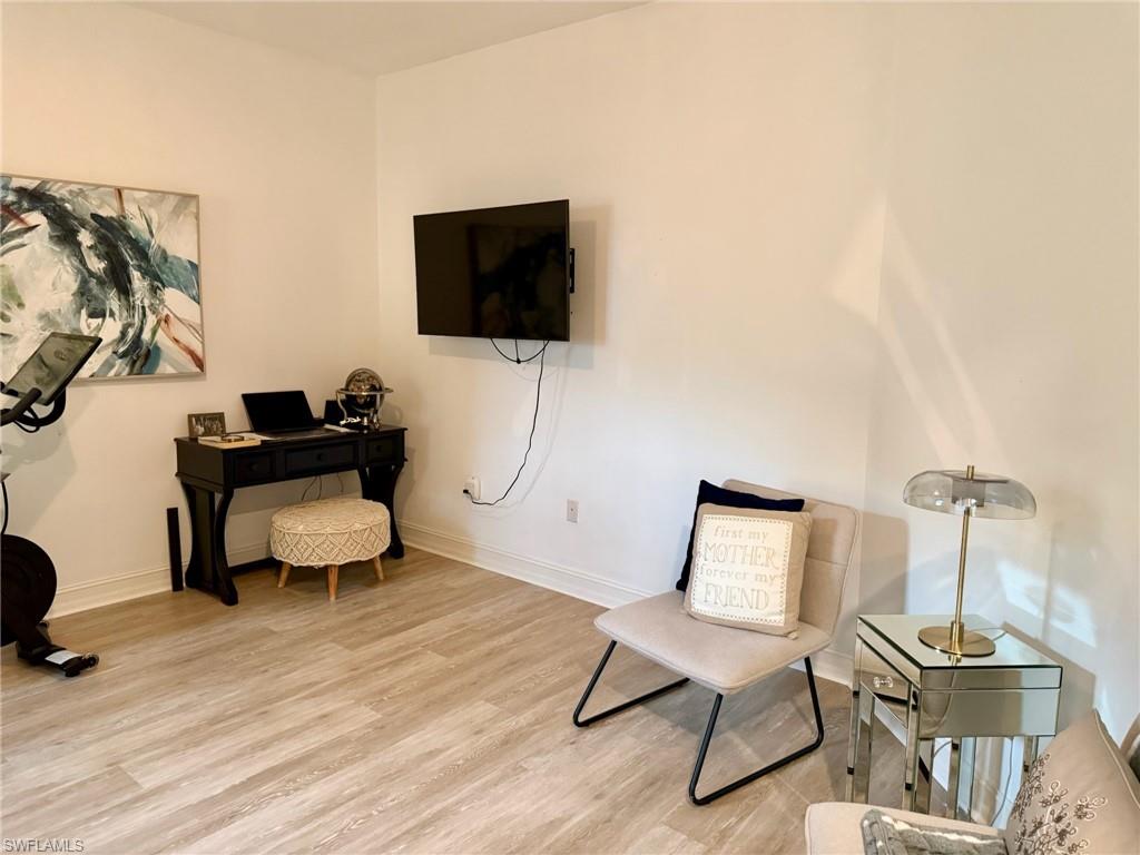 1252 Rialto Way, Unit 202 Naples, FL 34114 - Photo 20 of 26 a living room with furniture and a flat screen tv
