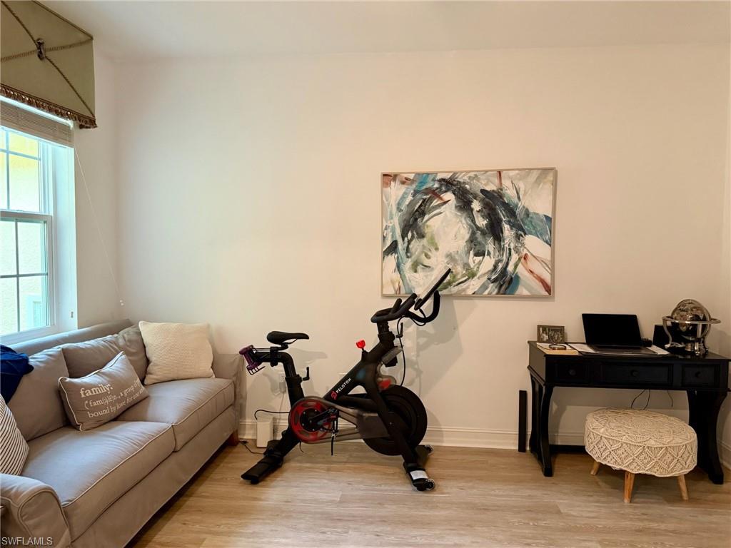 1252 Rialto Way, Unit 202 Naples, FL 34114 - Photo 21 of 26 a living room with furniture and wooden floor