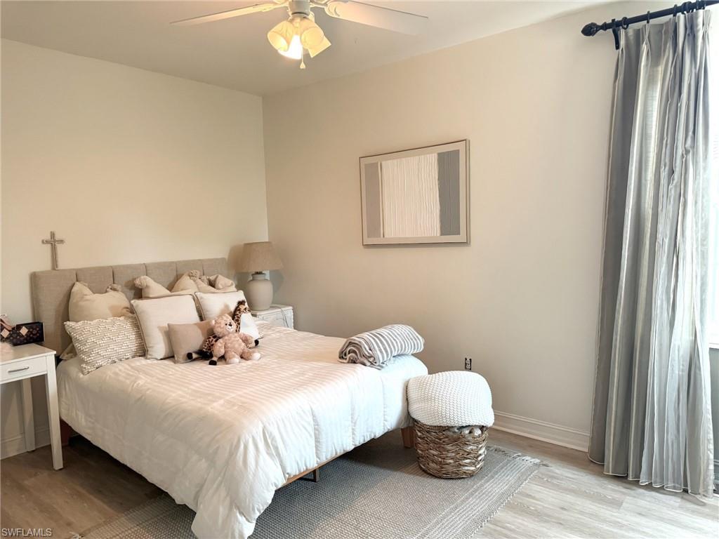 1252 Rialto Way, Unit 202 Naples, FL 34114 - Photo 22 of 26 a bedroom with bed and a window