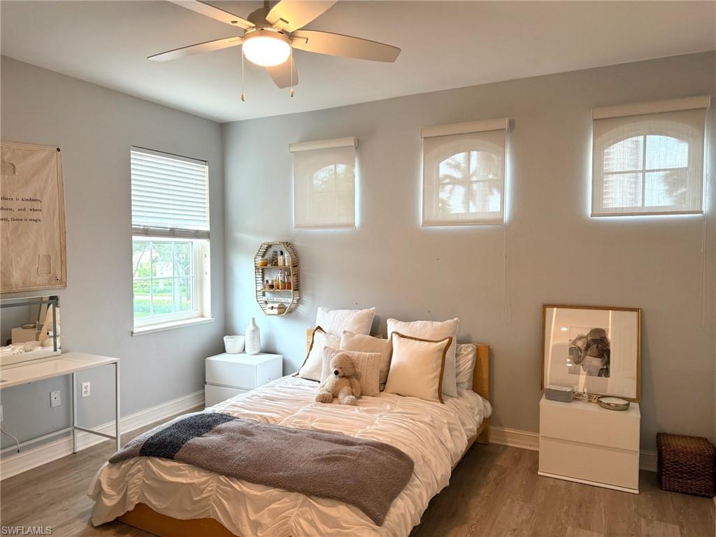1252 Rialto Way, Unit 202 Naples, FL 34114 - Photo 23 of 26 a bedroom with a bed and a window