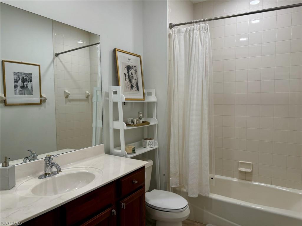 1252 Rialto Way, Unit 202 Naples, FL 34114 - Photo 24 of 26 a bathroom with a sink a toilet and shower