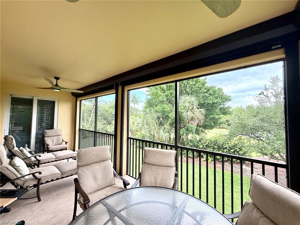 1252 Rialto Way, Unit 202 Naples, FL 34114 - Photo 5 of 26 a balcony with furniture and large windows