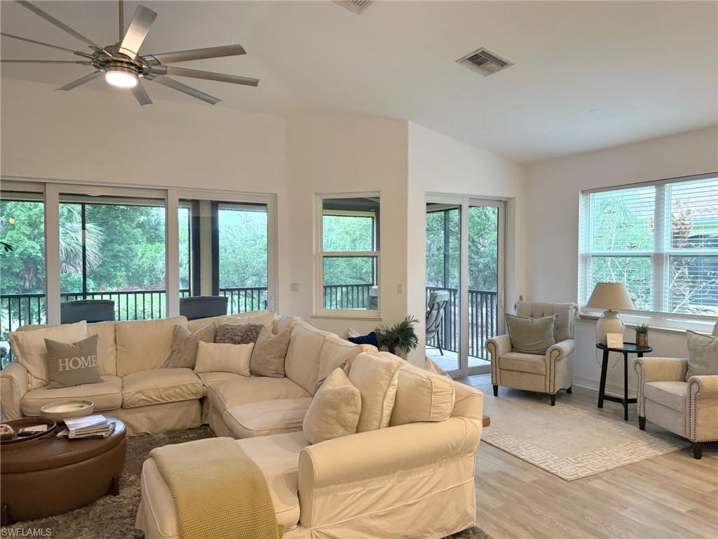 1252 Rialto Way, Unit 202 Naples, FL 34114 - Photo 7 of 26 a living room with furniture and a large window