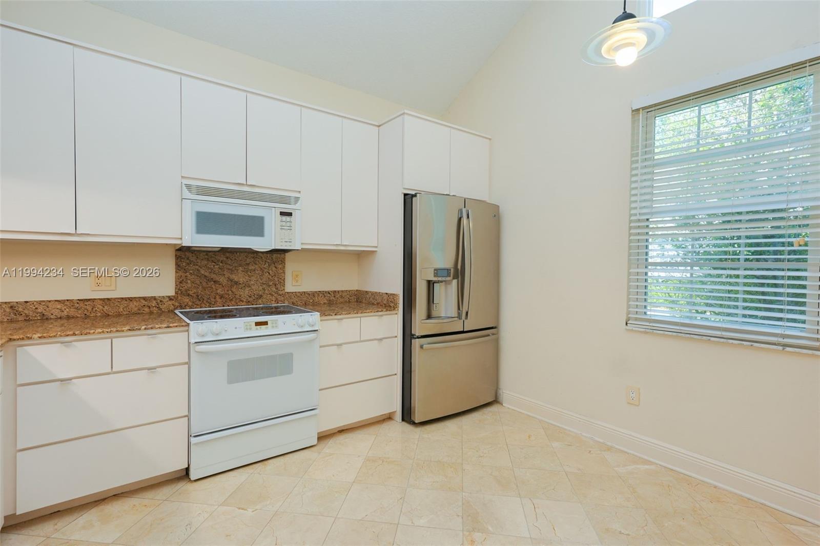113 Durham Place Longwood, FL 32779 - Photo 17 of 56 a kitchen with cabinets appliances and a counter space