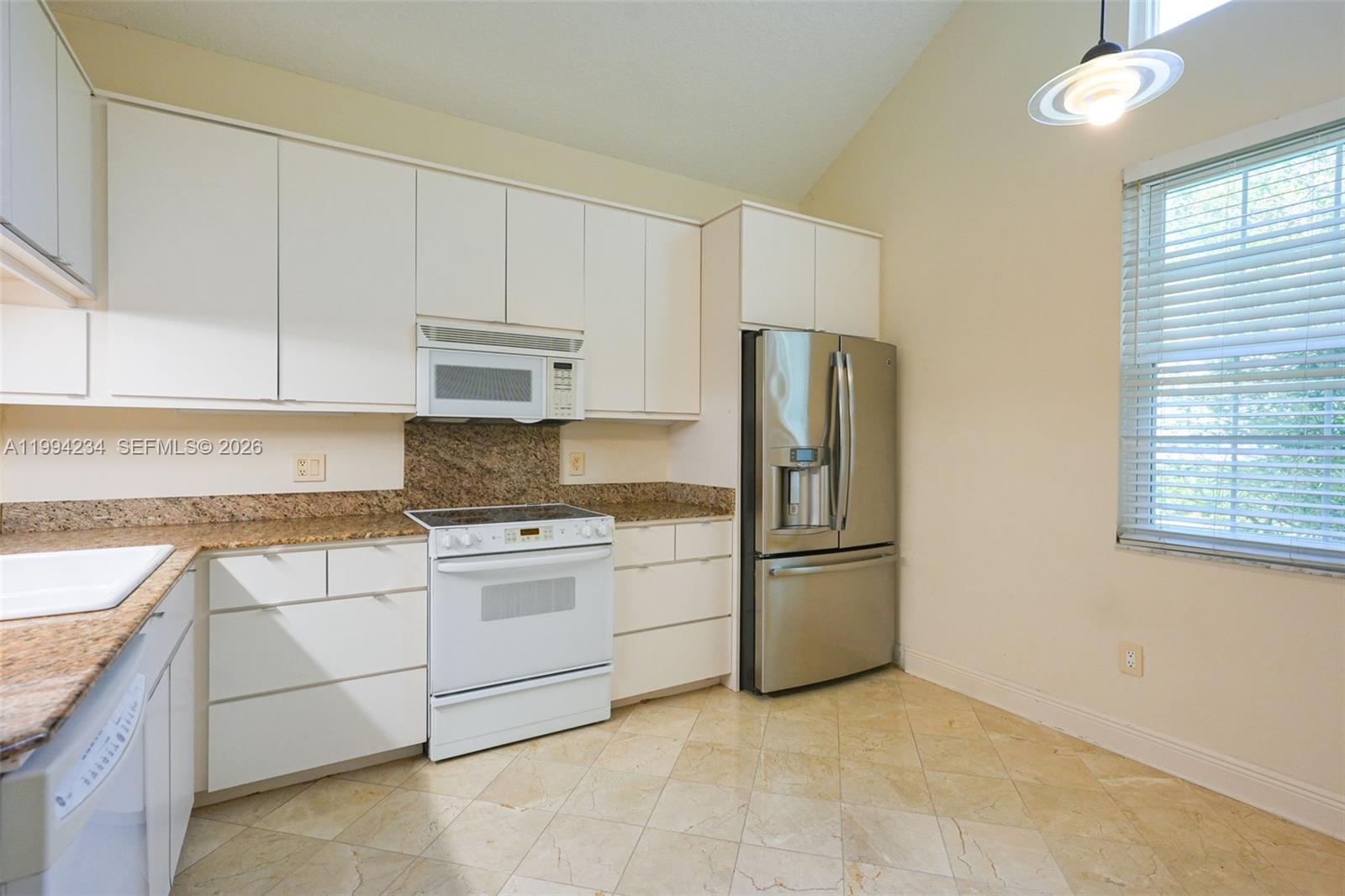 113 Durham Place Longwood, FL 32779 - Photo 18 of 56 a kitchen with stainless steel appliances granite countertop a refrigerator sink and stove