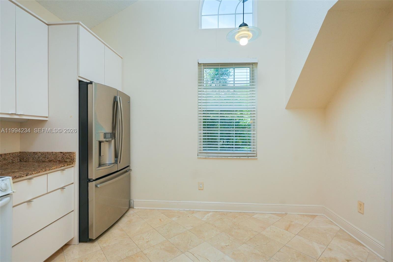 113 Durham Place Longwood, FL 32779 - Photo 19 of 56 a view of a refrigerator a kitchen island wooden cabinets and a window