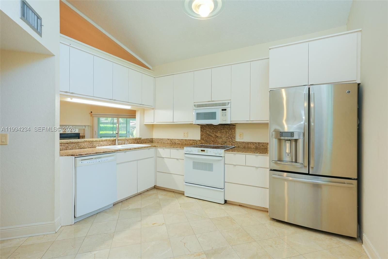 113 Durham Place Longwood, FL 32779 - Photo 20 of 56 a kitchen with white cabinets and white stainless steel appliances