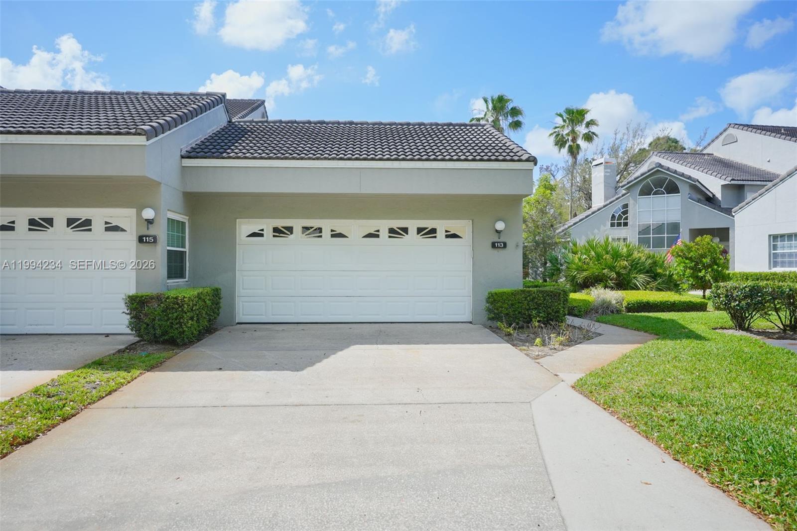 113 Durham Place Longwood, FL 32779 - Photo 2 of 56 a front view of a house with a yard and garage
