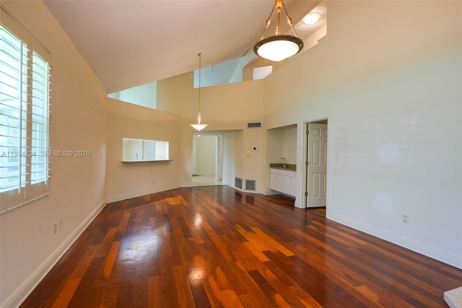 113 Durham Place Longwood, FL 32779 - Photo 27 of 56 a view of an empty room with wooden floor and a window