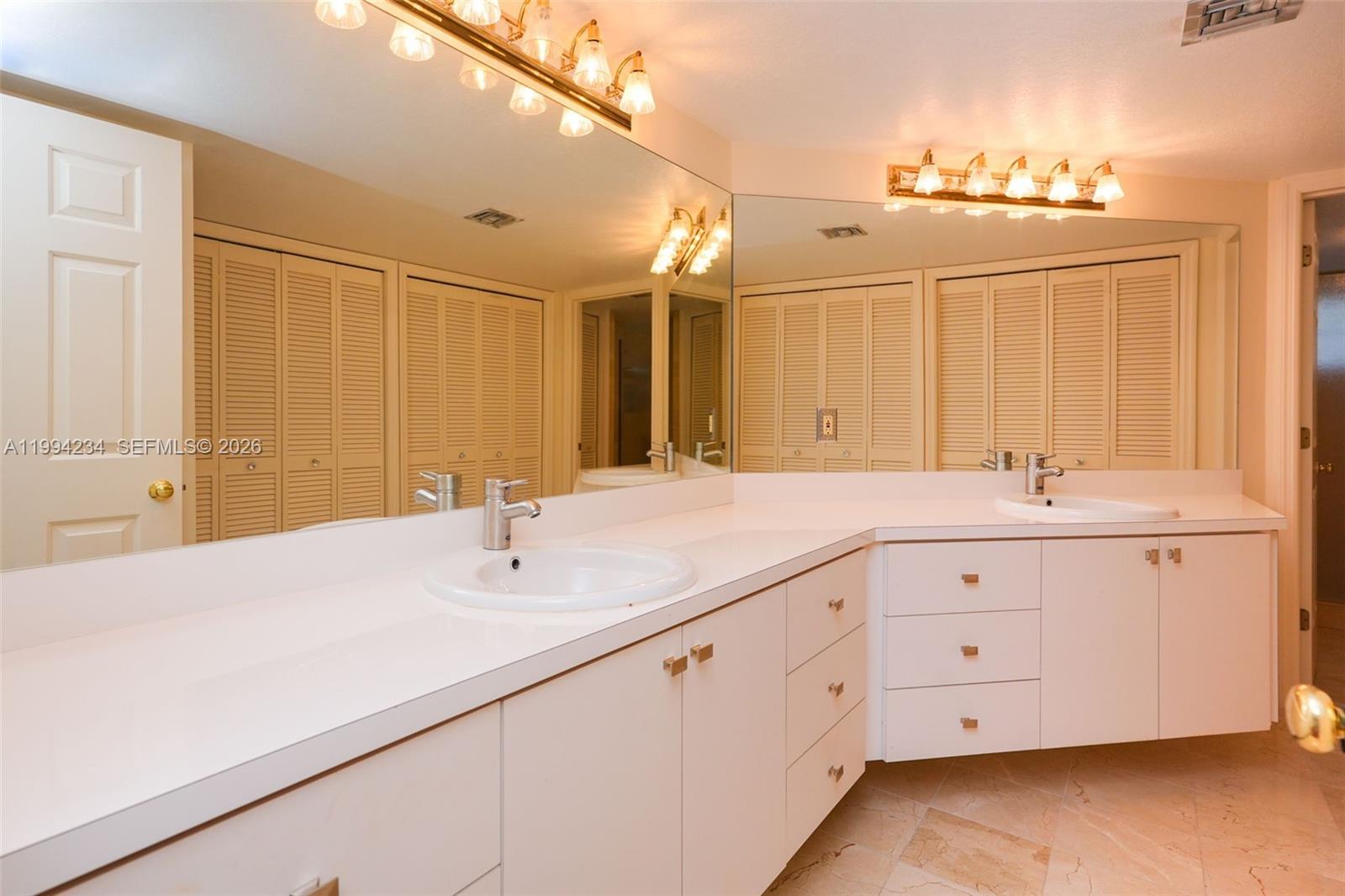 113 Durham Place Longwood, FL 32779 - Photo 30 of 56 a bathroom with double sink and a mirror