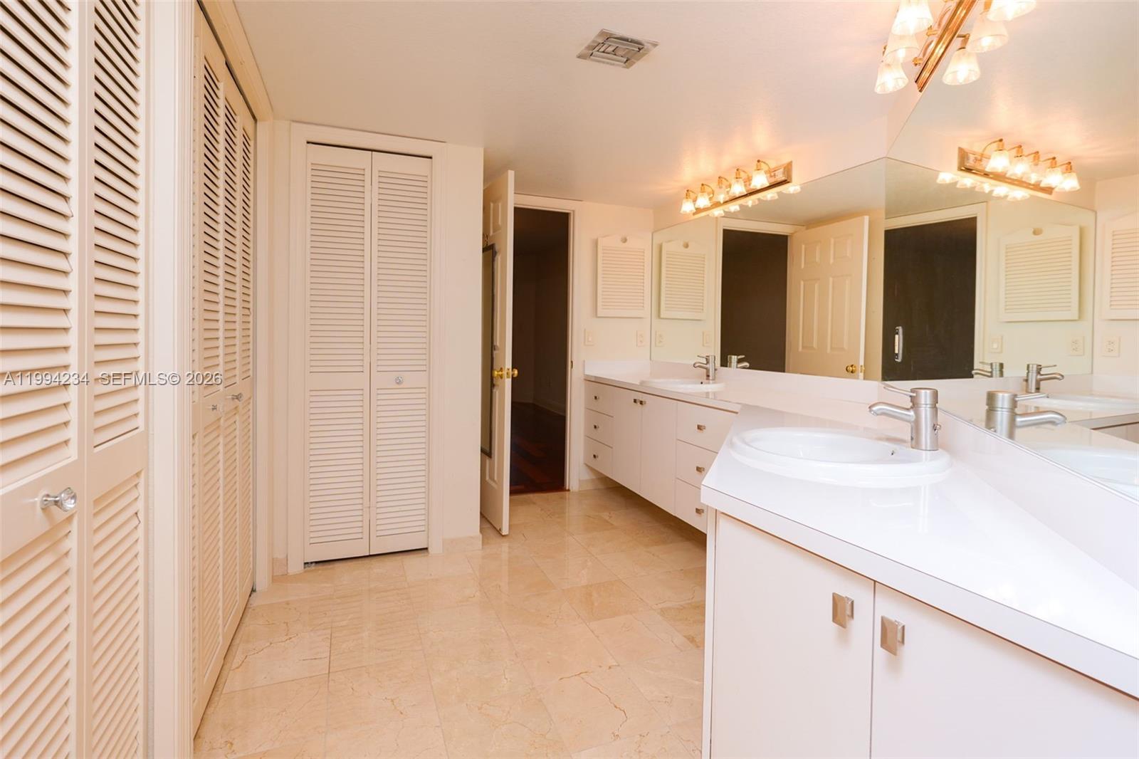 113 Durham Place Longwood, FL 32779 - Photo 32 of 56 a bathroom with a sink vanity and a mirror