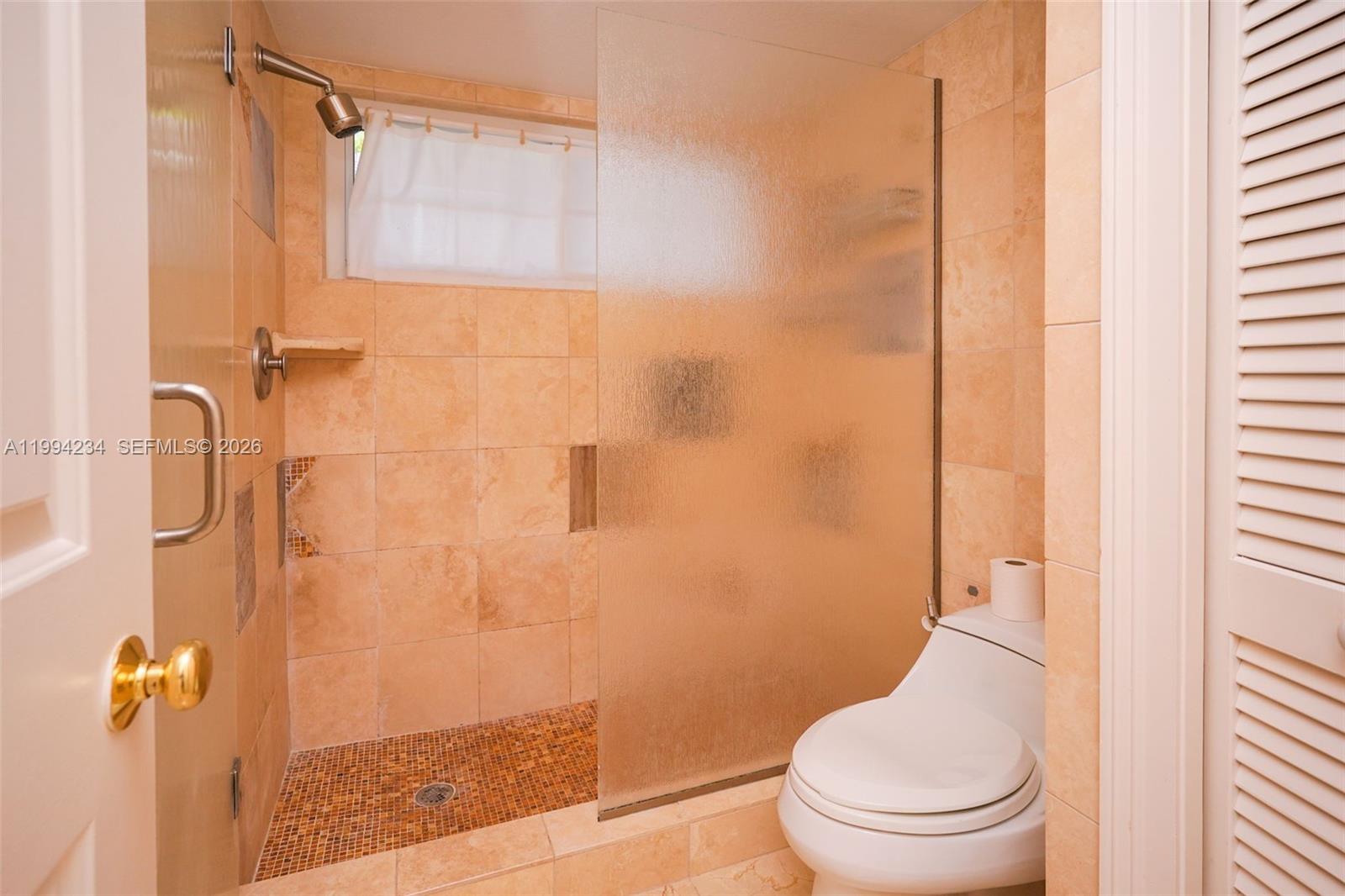 113 Durham Place Longwood, FL 32779 - Photo 33 of 56 a white toilet sitting next to a shower curtain