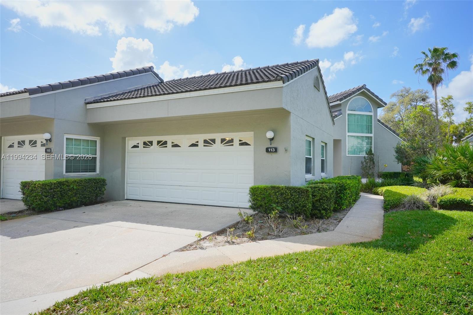 113 Durham Place Longwood, FL 32779 - Photo 4 of 56 a front view of a house with a yard and garage