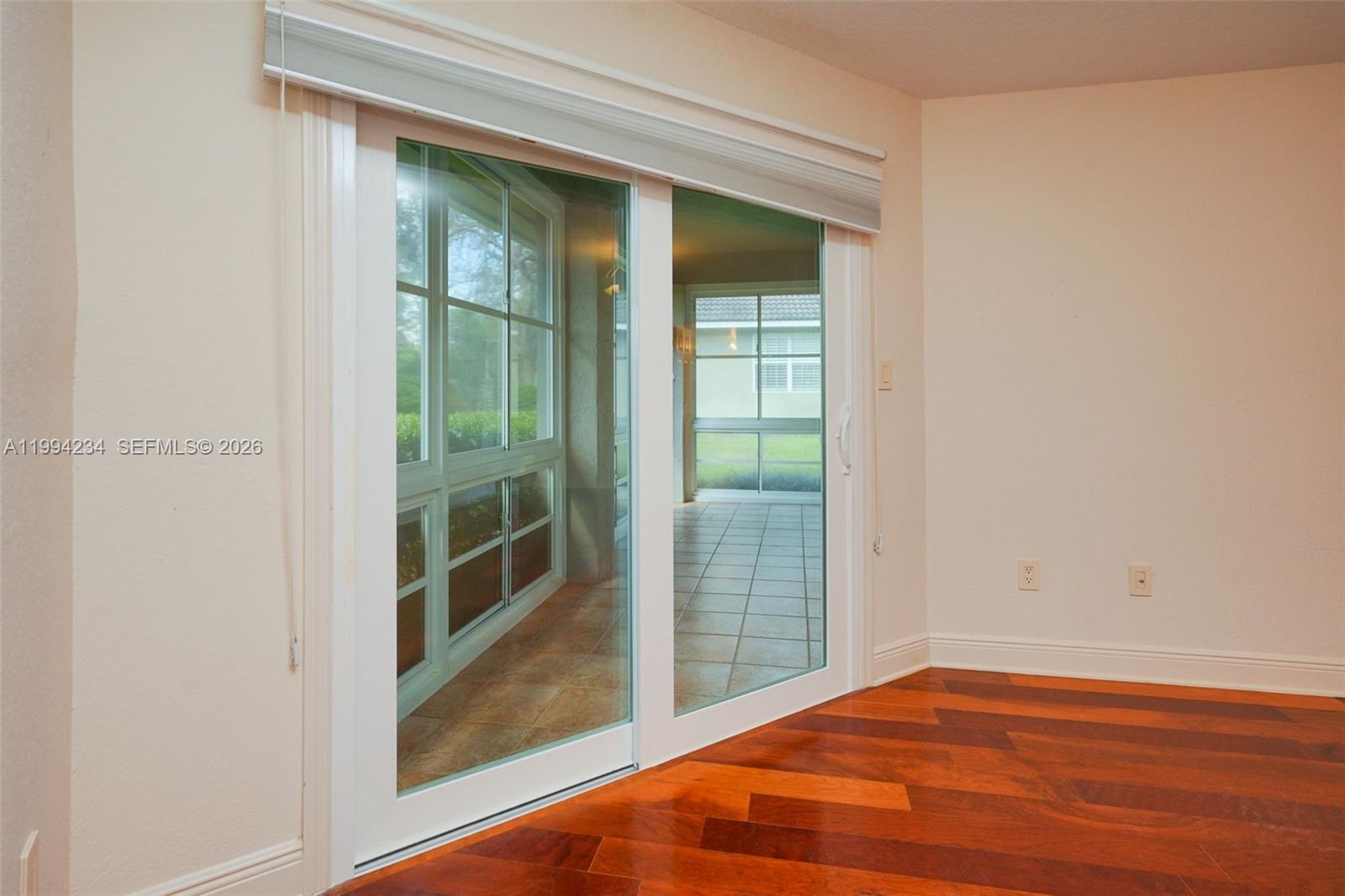 113 Durham Place Longwood, FL 32779 - Photo 43 of 56 a view of an empty room with wooden floor and a window