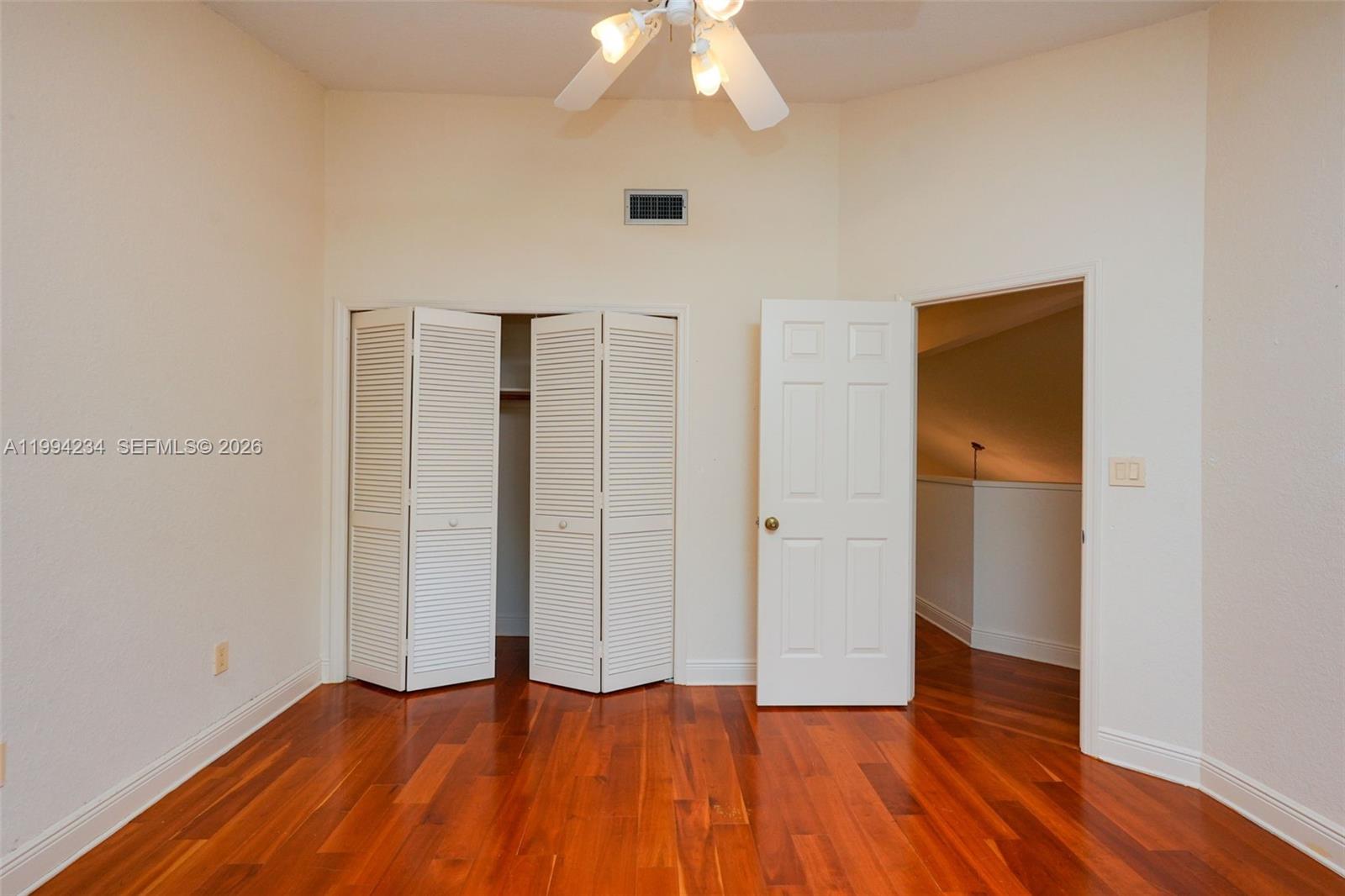113 Durham Place Longwood, FL 32779 - Photo 49 of 56 wooden floor in an empty room with a window