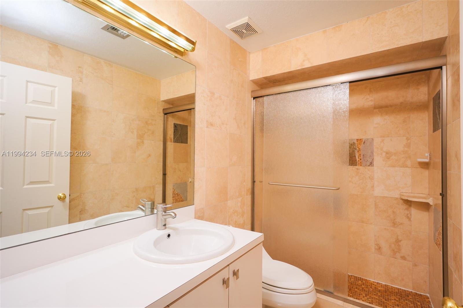113 Durham Place Longwood, FL 32779 - Photo 50 of 56 a bathroom with a sink a toilet and shower