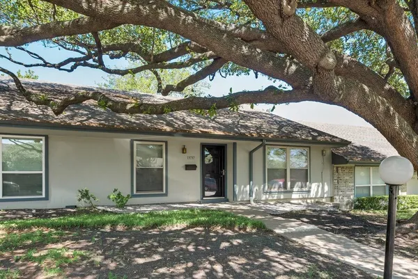 front view of a house with a tree