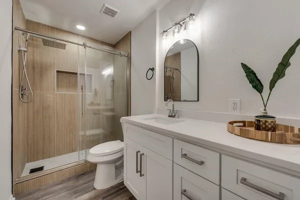 a bathroom with a toilet sink and shower