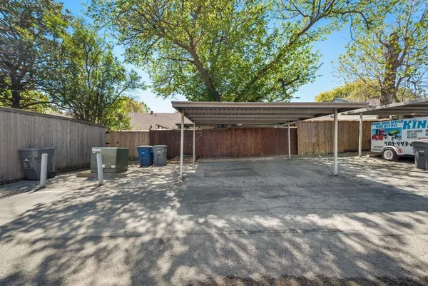 a view of a house with wooden deck and furniture