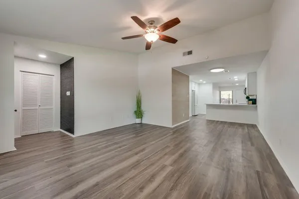 a view of an empty room and wooden floor